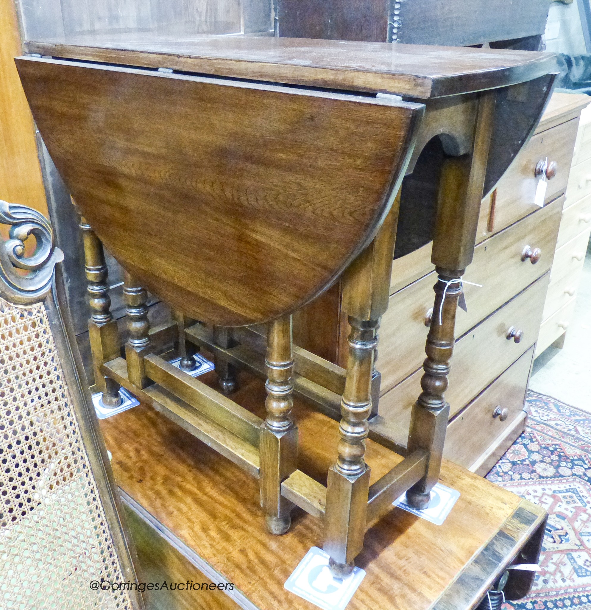 An 18th century style oval oak gateleg table, 100cm extended, depth 83cm, height 74cm